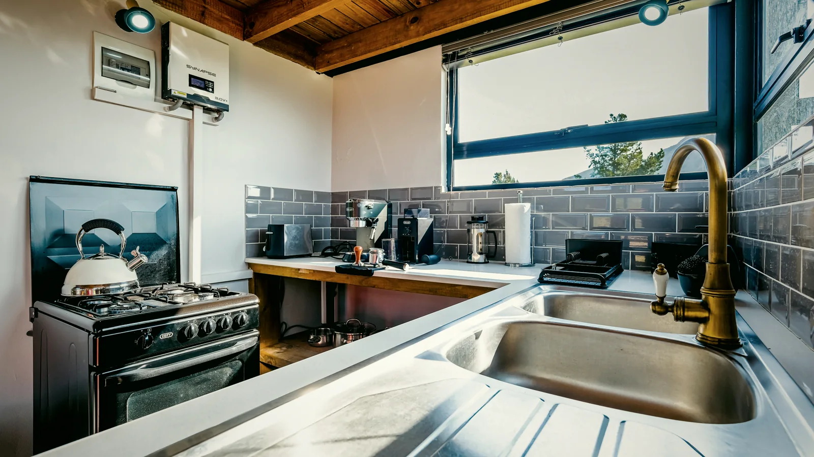 Kitchen with gas oven, espresso machine and mountain light